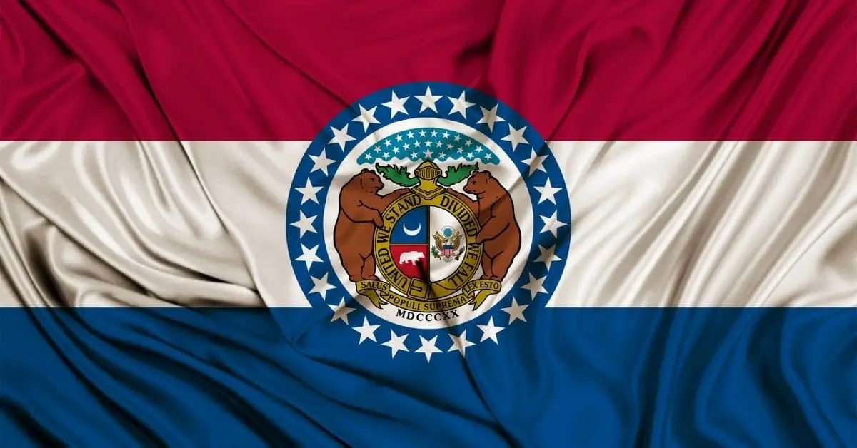 This is an image of the state flag of Missouri, featuring red, white, and blue stripes with the Missouri CNA License seal in the center.