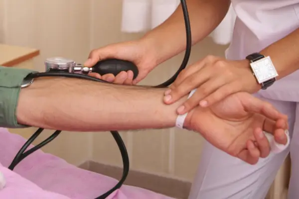 A nurse checks a patient's blood pressure using a sphygmomanometer.
